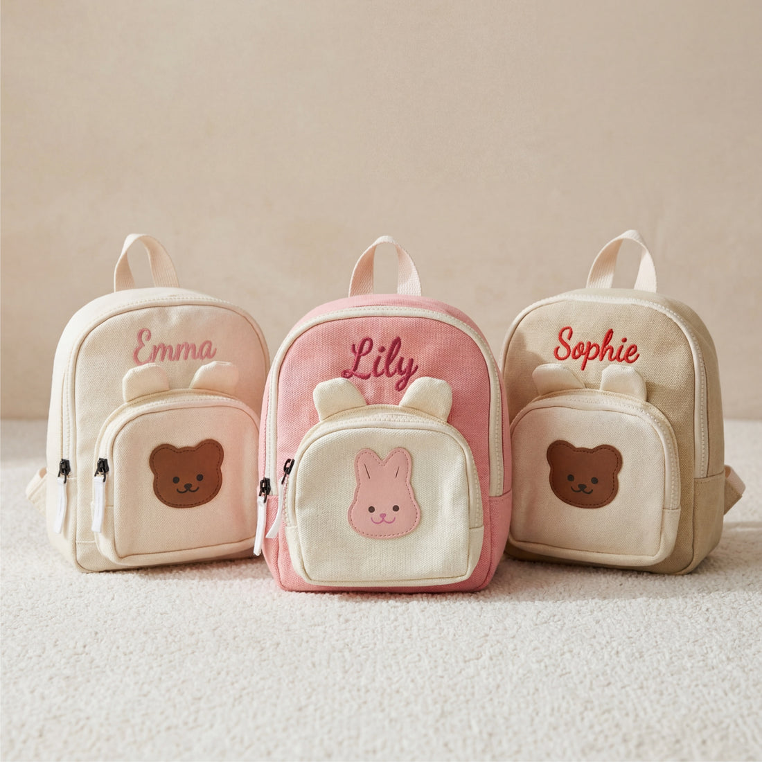 Personalized canvas baby backpacks with bear and bunny face pockets and embroidered names