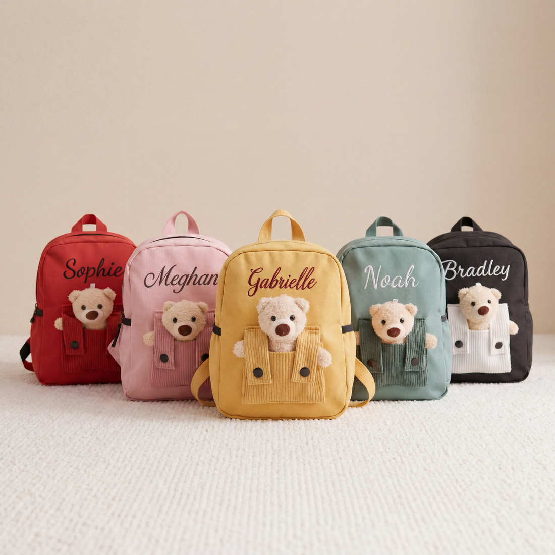 Personalized toddler backpacks with removable teddy bear in corduroy front pocket and embroidered names